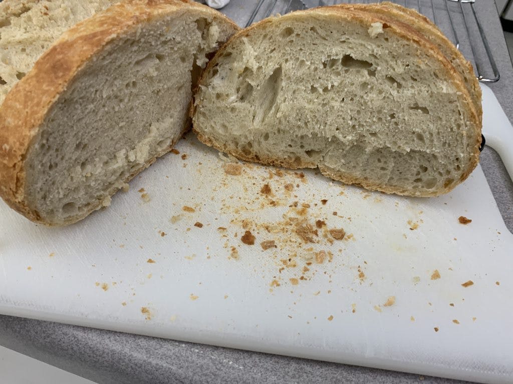 A cross-section of a loaf of bread cut across it to show the crumb structure.