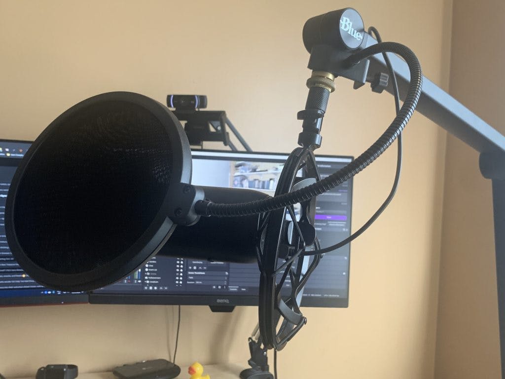 Blue Yeti attached to a microphone stand with a pop filter.
